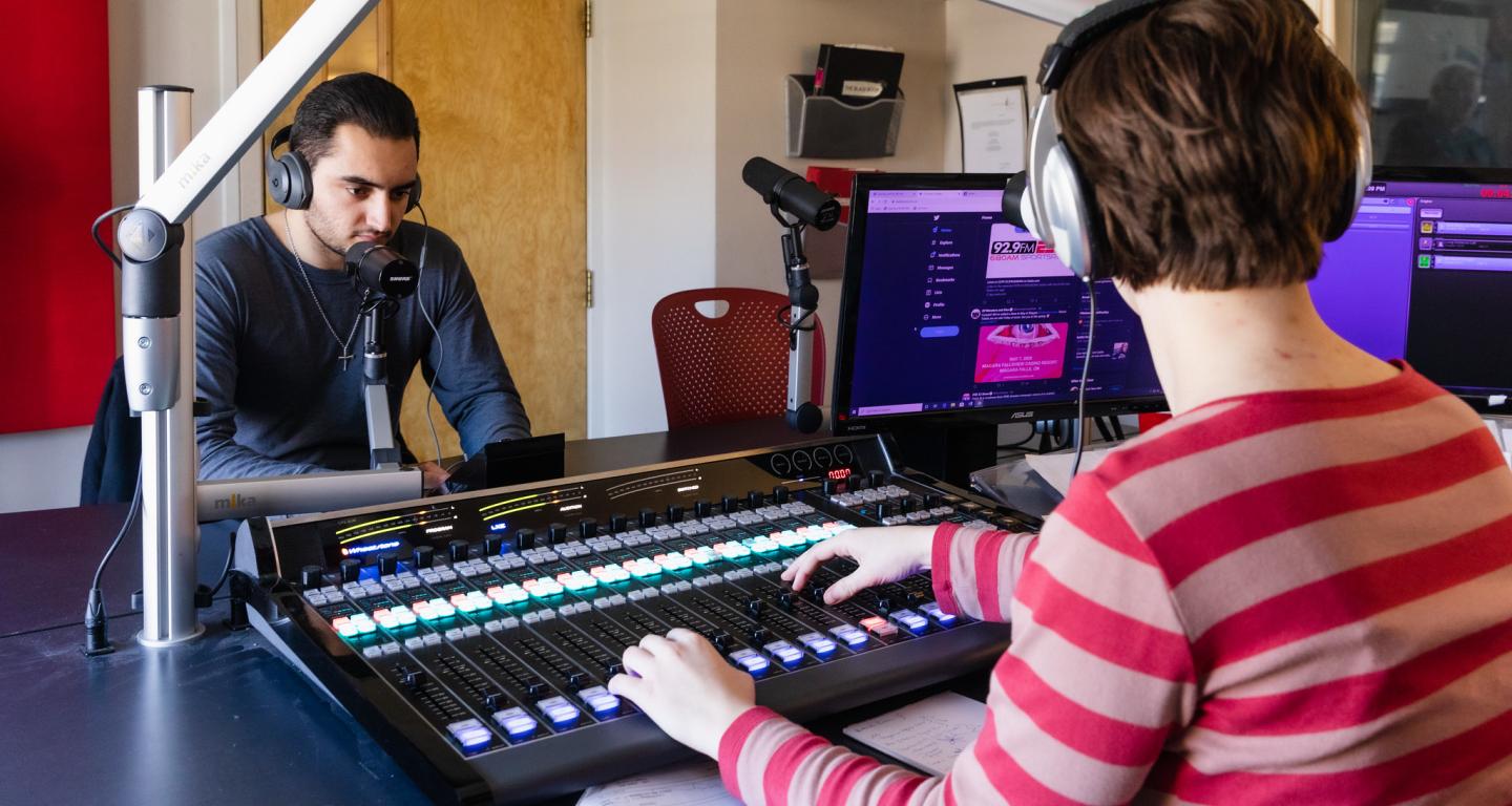 Two North Central College students use the new Wheatstone console at WONC radio.