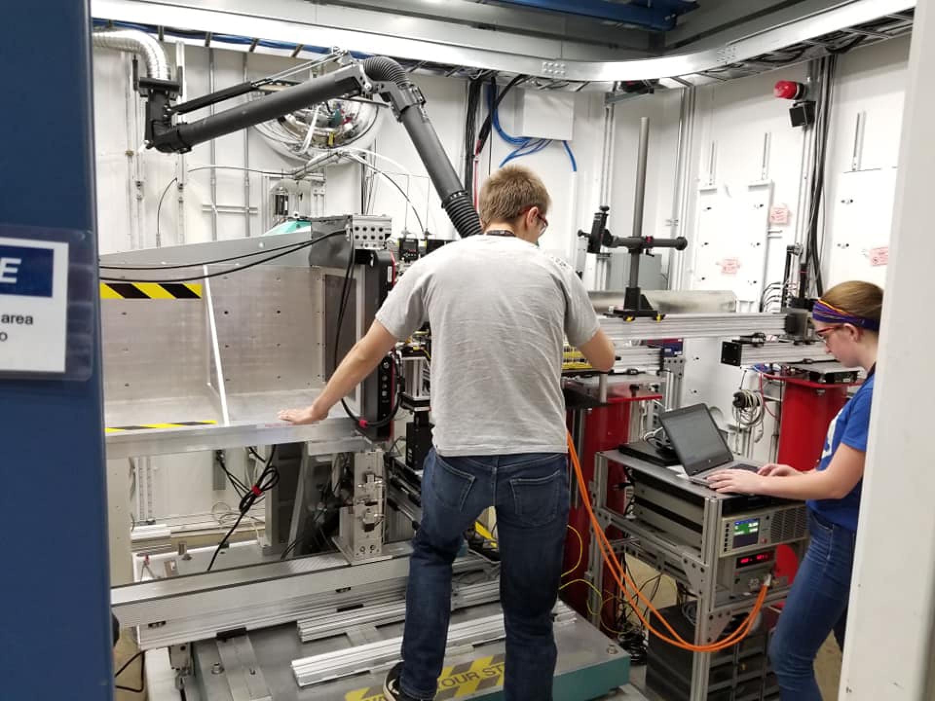 Samuel Lee and Morgan Fellows replace ionic liquid samples on the X-ray instrument.