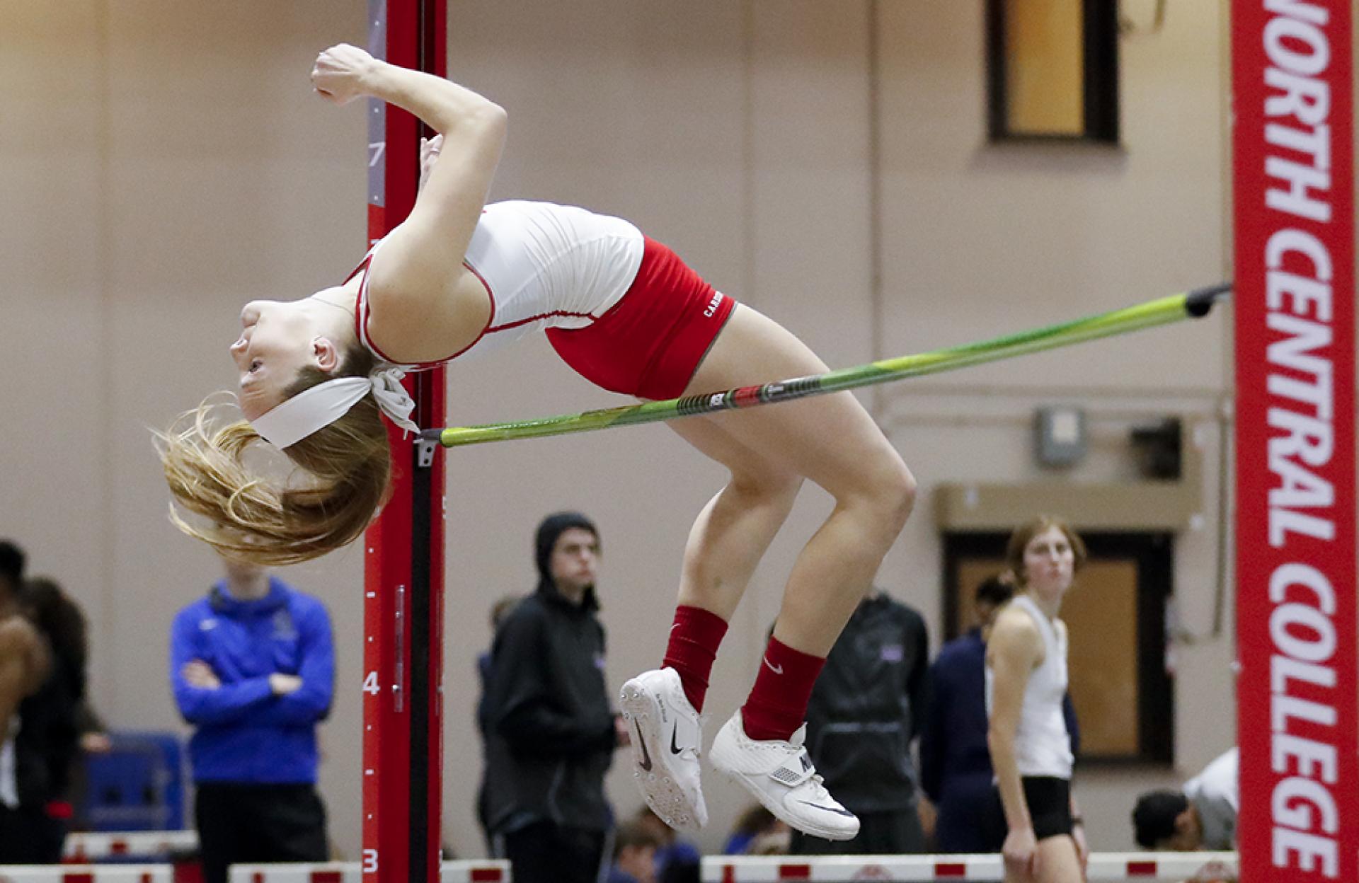 High jumper Taiah Gallisath clears the bar during a North Central College women's track meet.