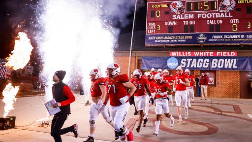 The North Central football team runs onto the field at the Stagg Bowl.