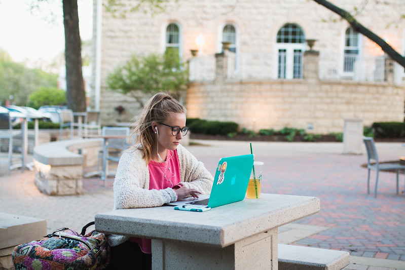 Student outside on laptop