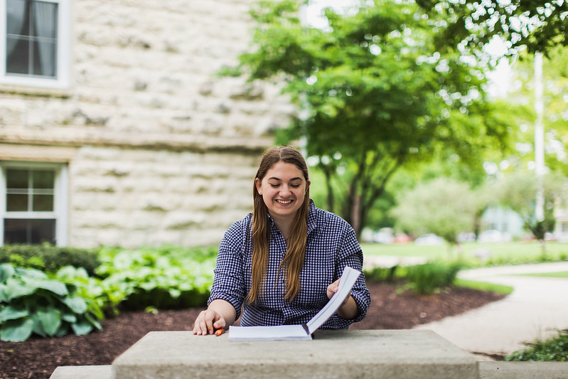 Student sitting outside at table