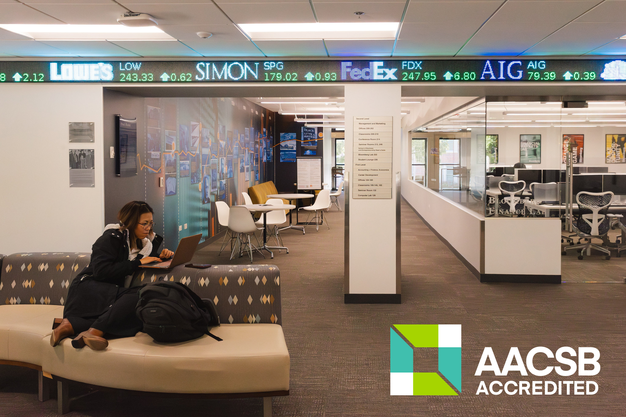 A student working on a laptop in the School of Business & Entrepreneurship.