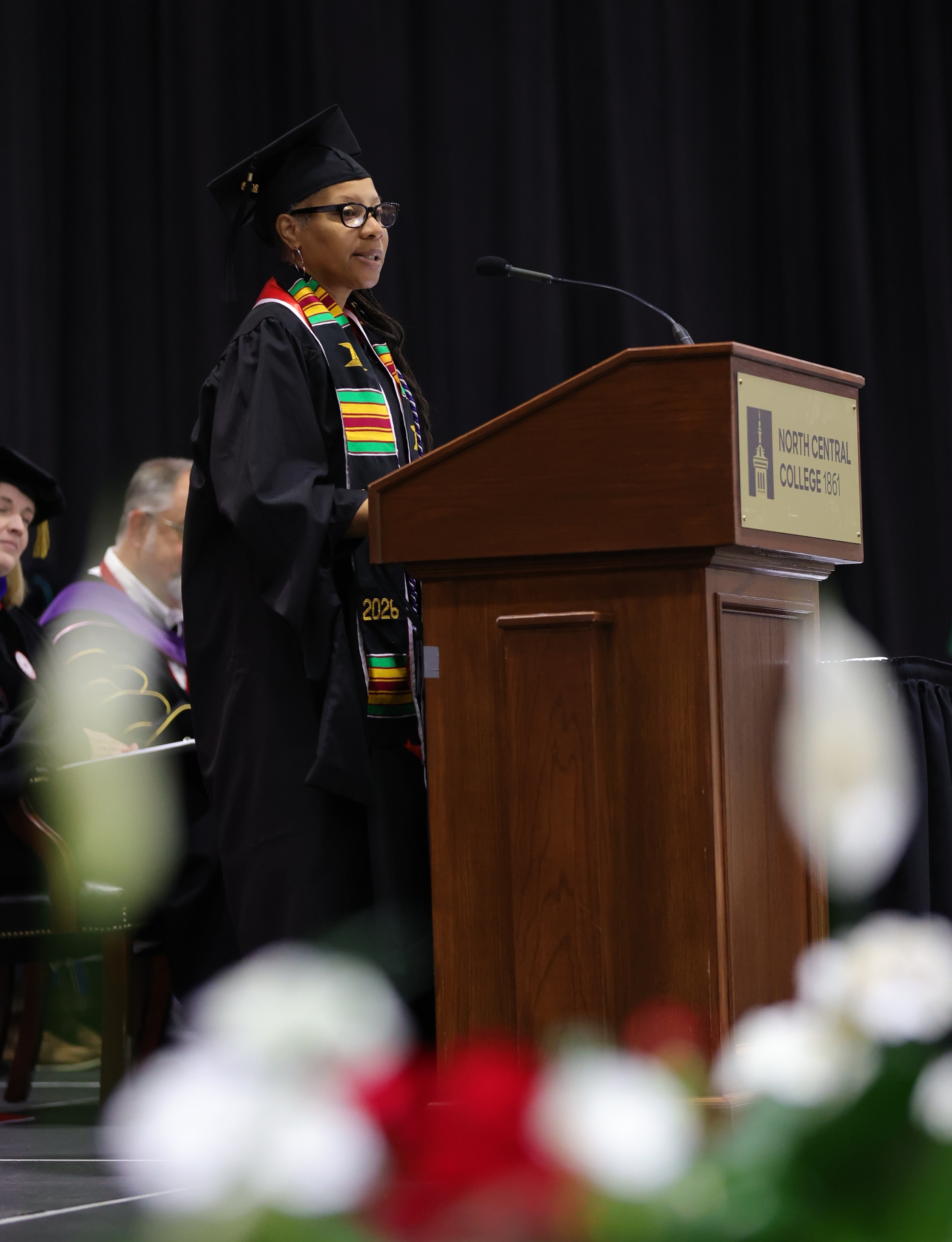 A photo of the graduate speaker Chantell Windham at the podium during Commencement.