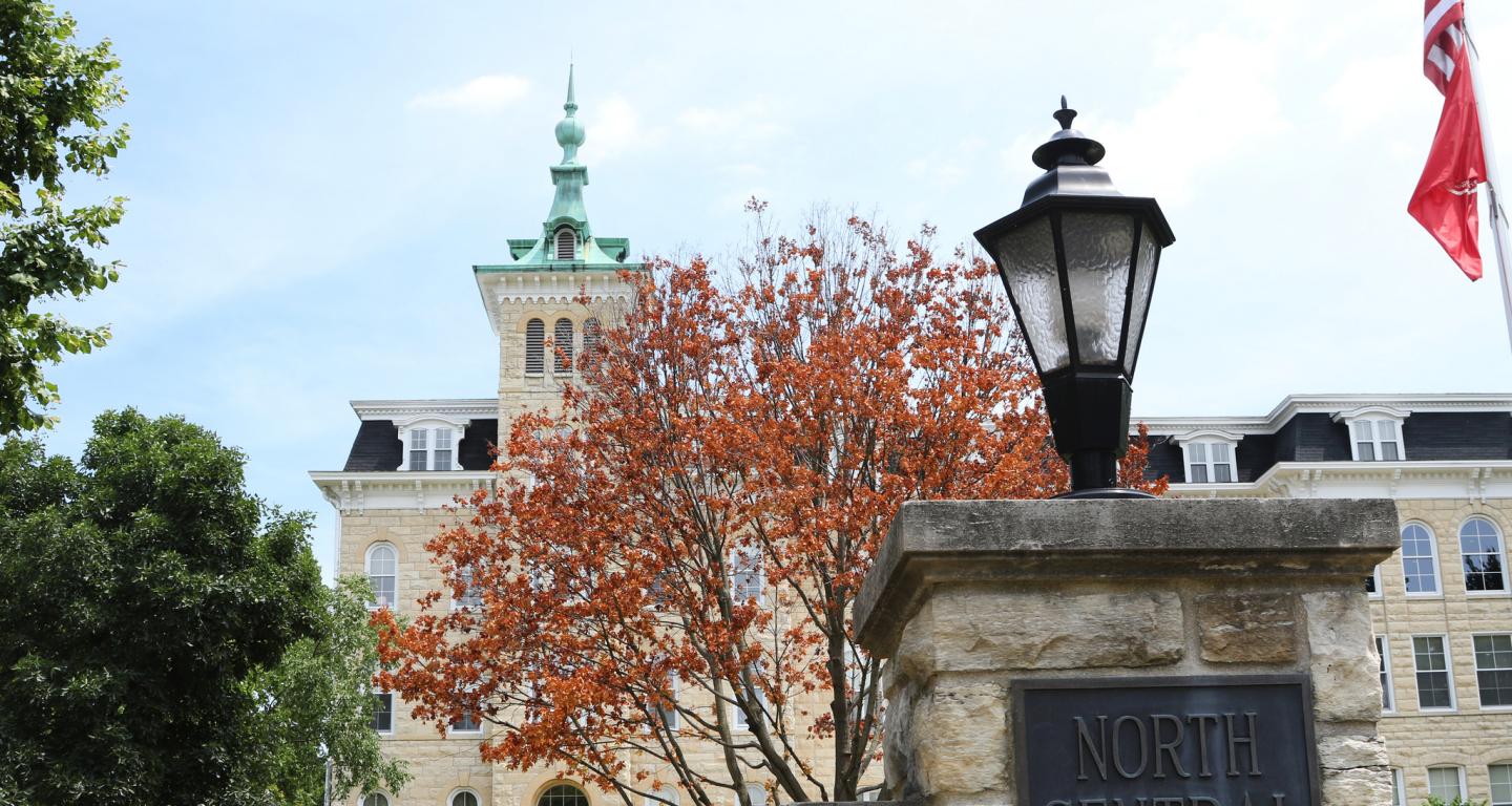 North Central College Campus, Old Main behind College Signage