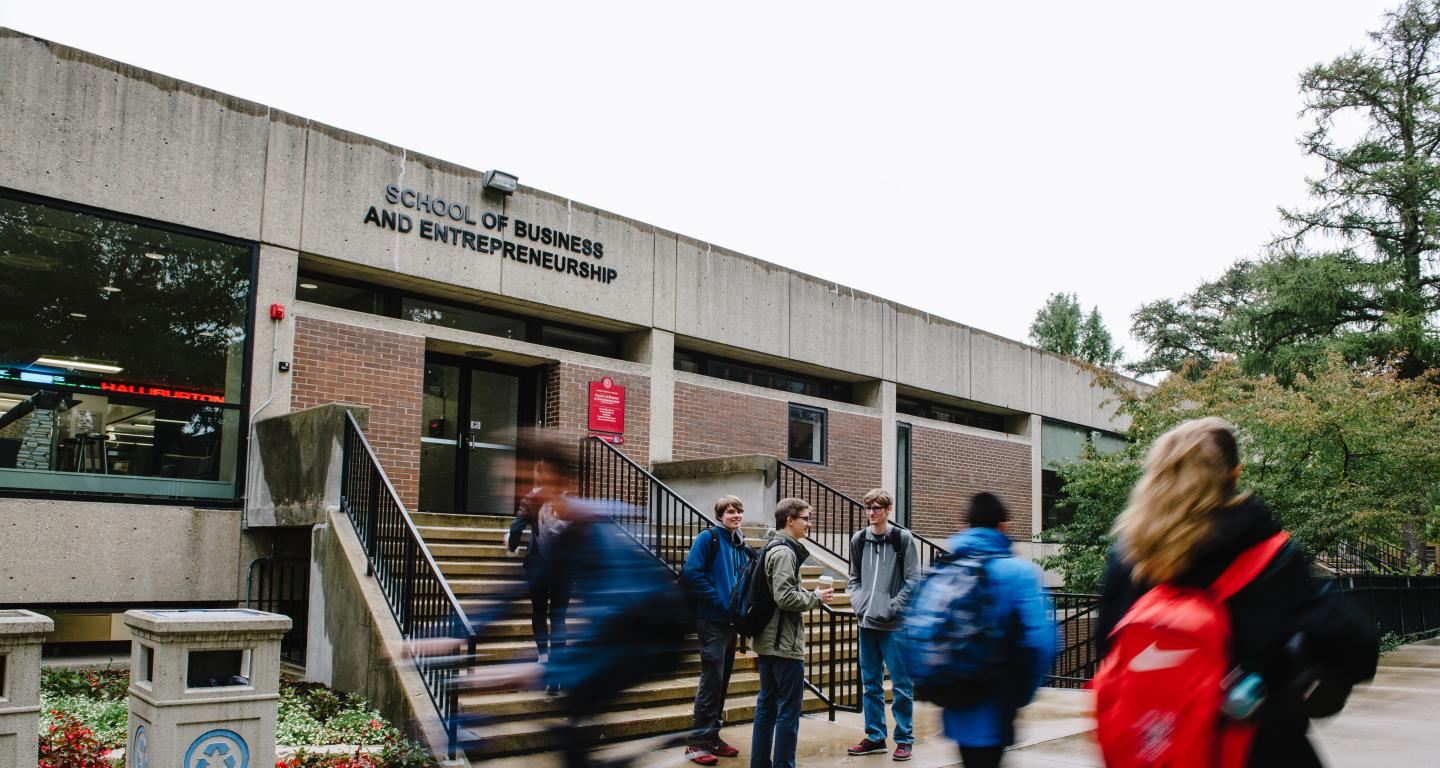 students walking passed school of business and entrepreneurship 