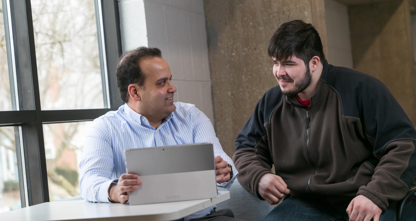 student and professor smiling