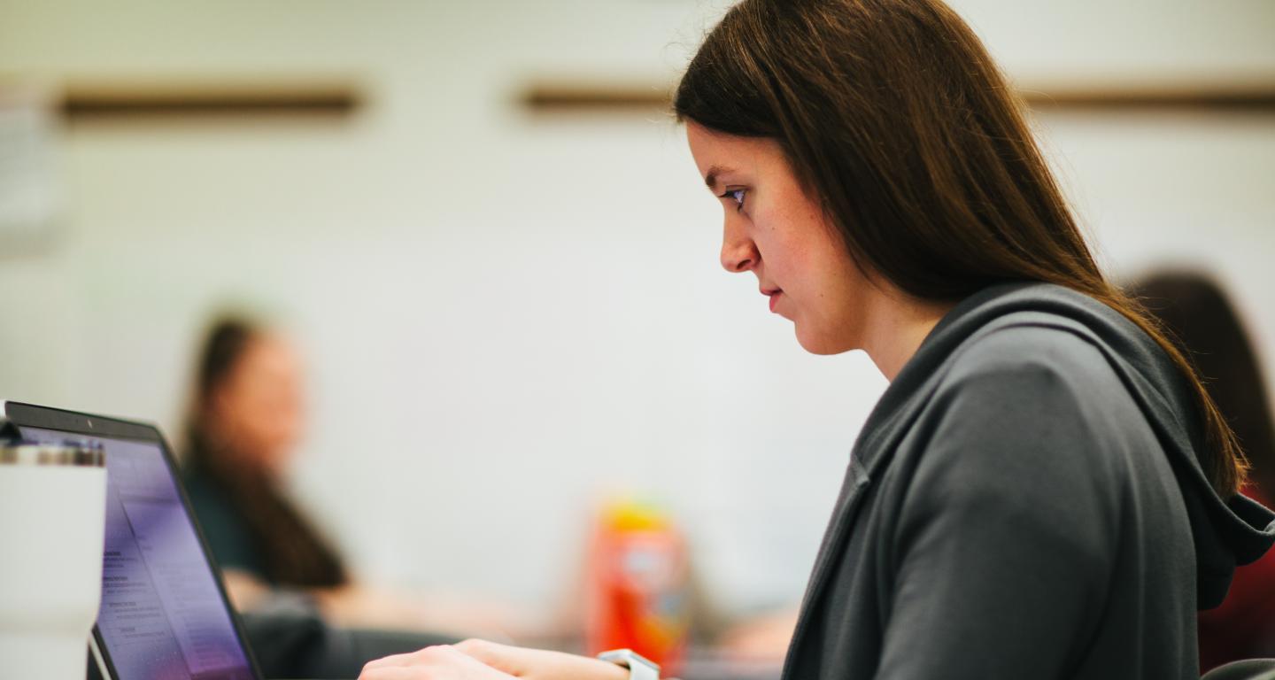 graduate student studying on laptop