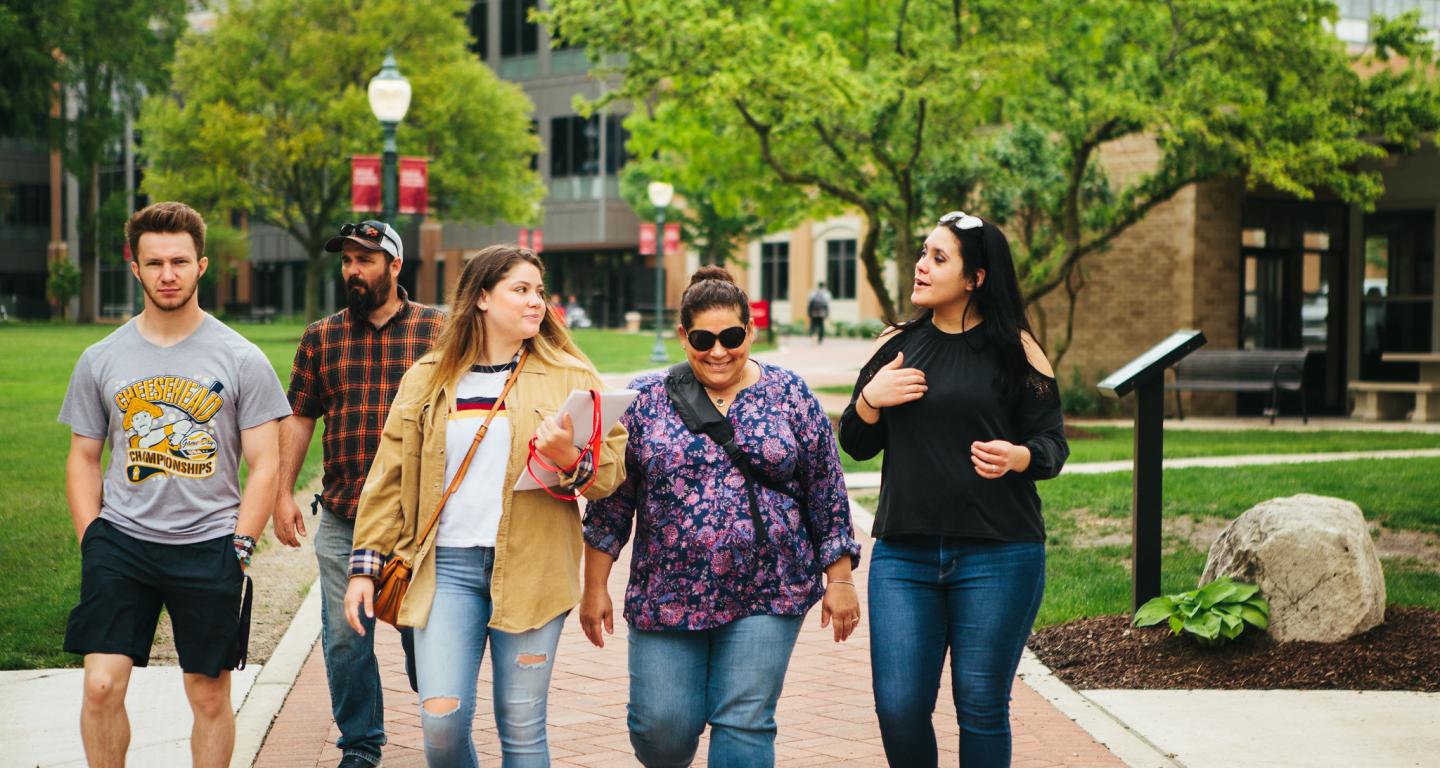 A North Central College student admission ambassador leads a campus tour.