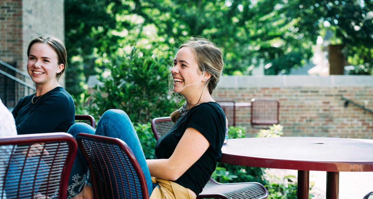 Two North Central College students talking during a Cardinal Conversation.