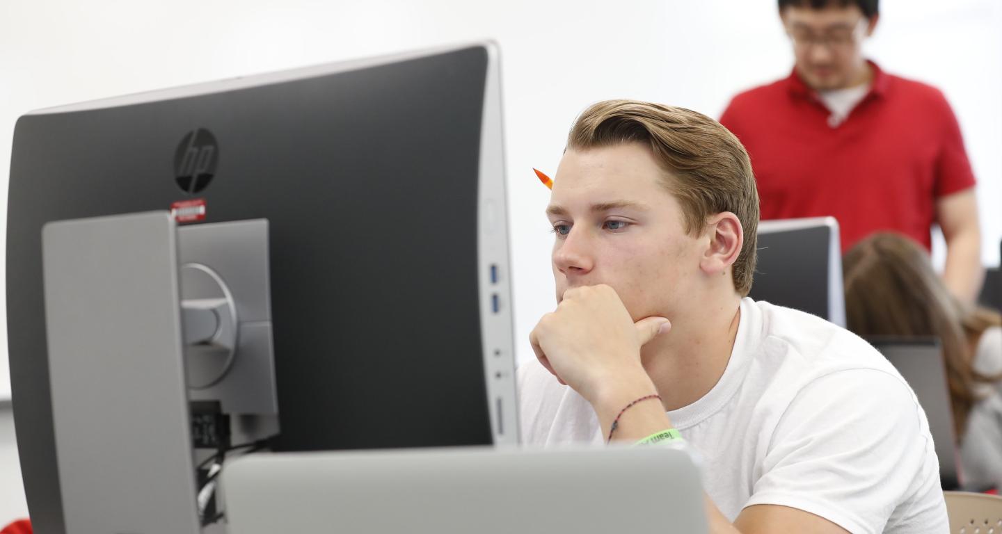 A student typing up their admission essay.