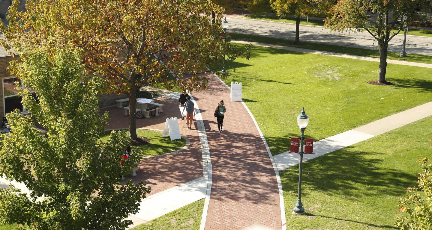 students walking on walkway through campus