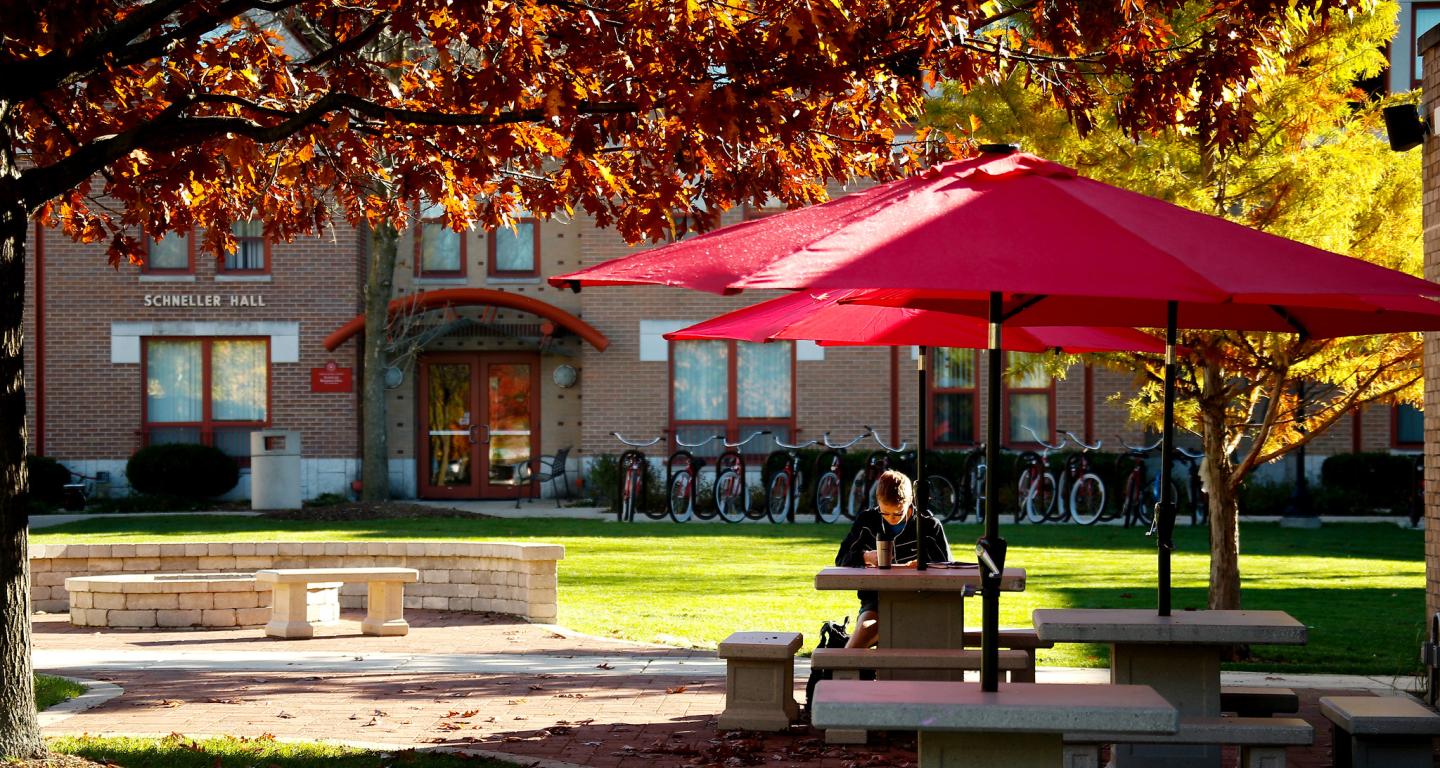 Student sitting at table outside