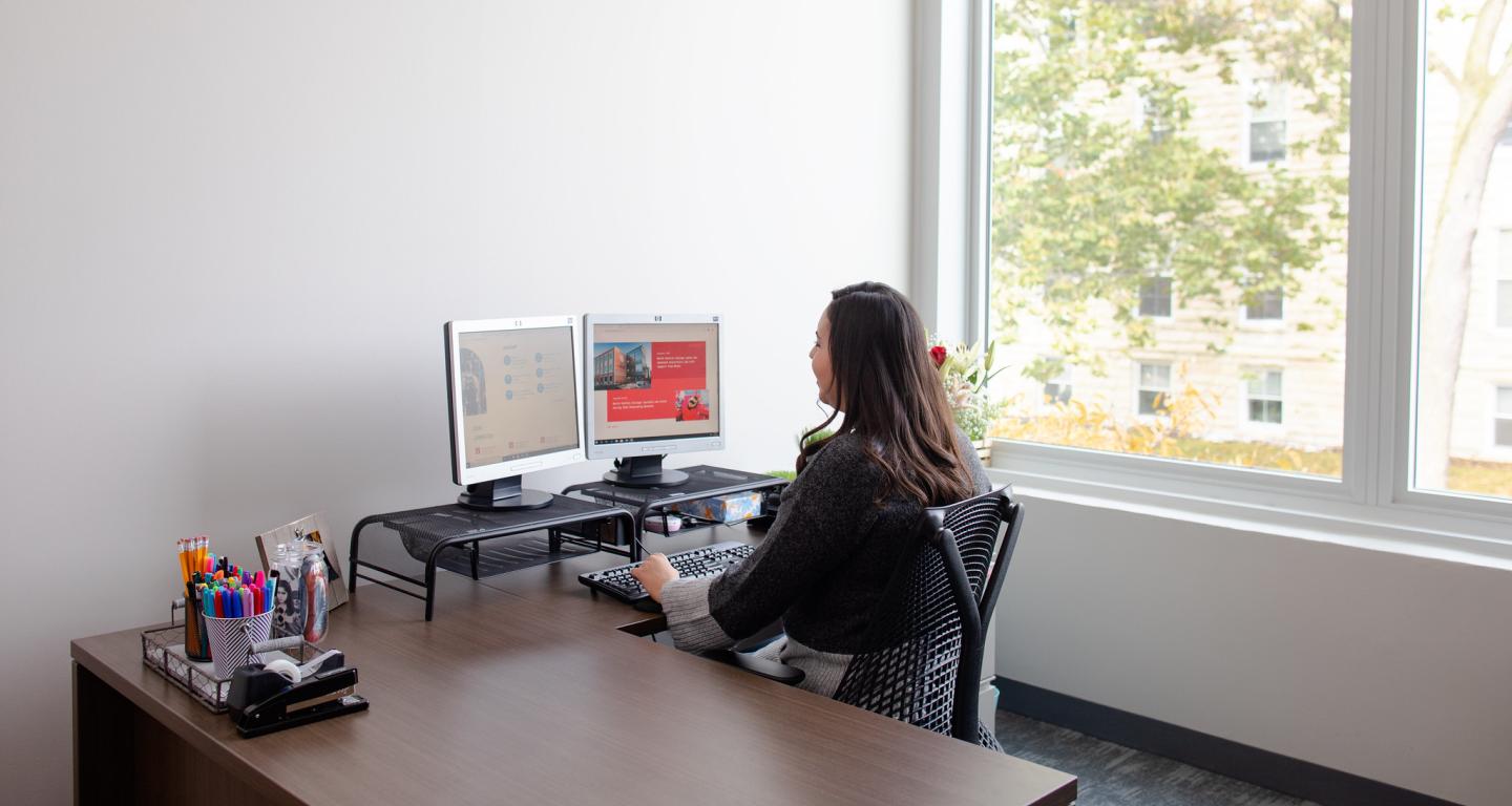 A North Central College student working on a cover letter.