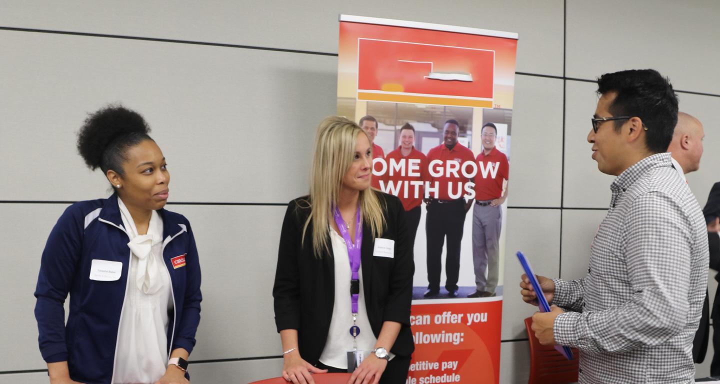 A North Central College talks with recruiters at a job fair.