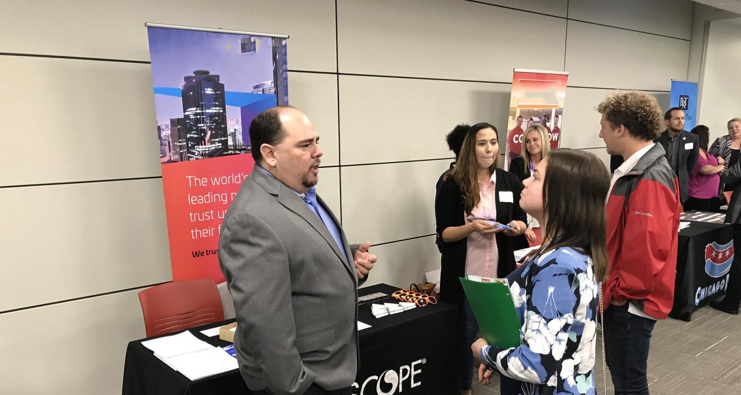 A North Central College student speaks with a recruiter at a job fair.