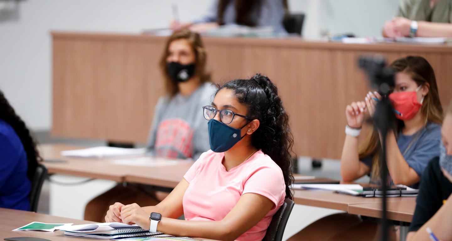 An anthropology student at North Central College listening to a lecture.