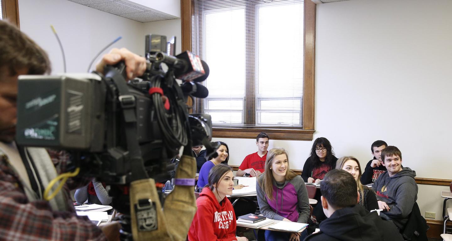 A class of North Central College film studies students practices being filmed.