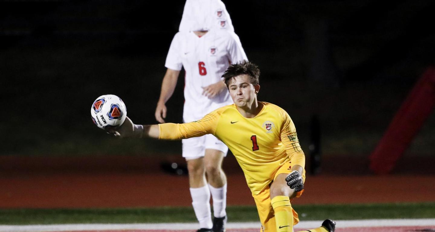 A goalie from the North Central College men's soccer team throws a ball.