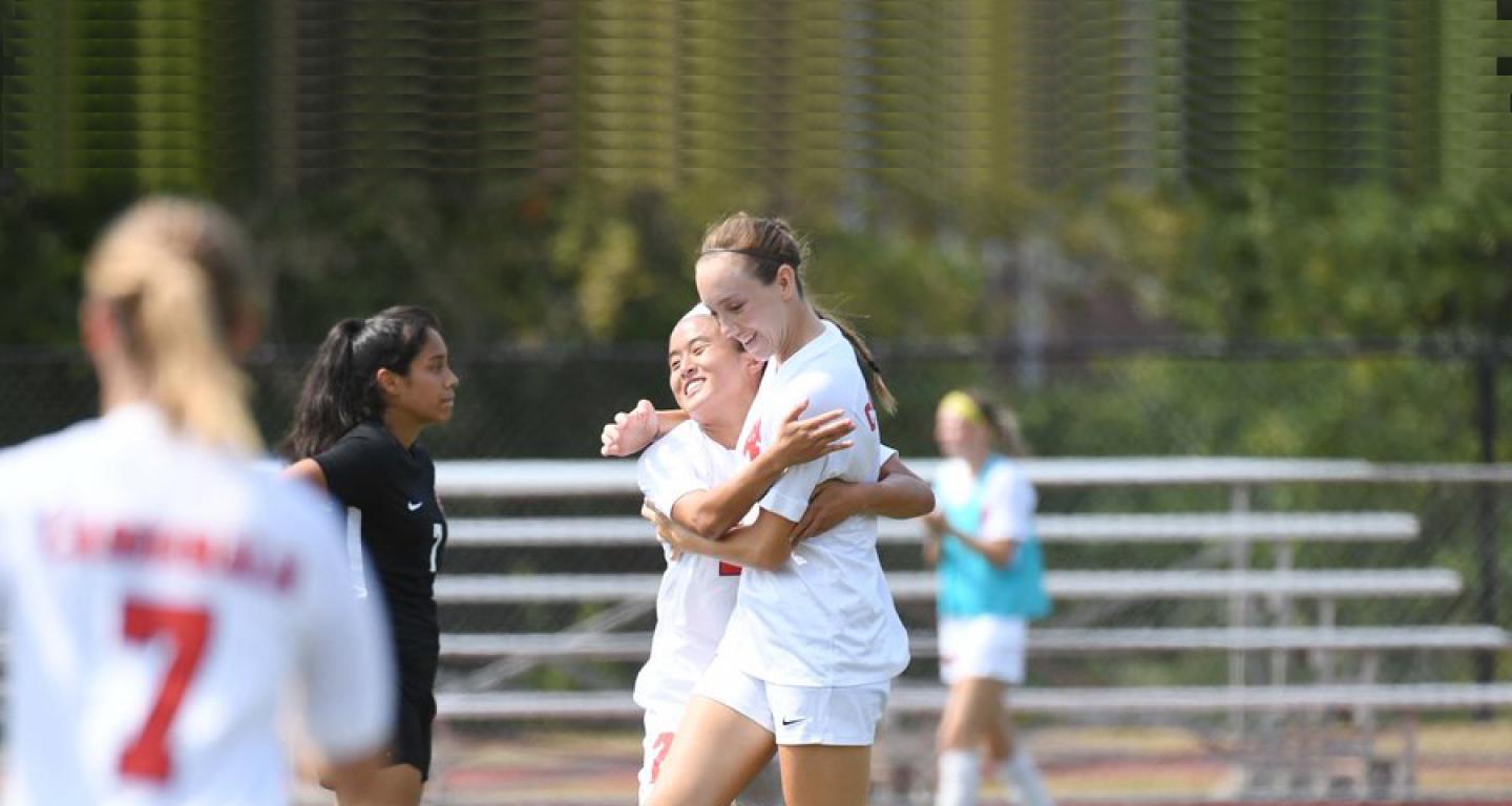 Members of the North Central College women's soccer team share a celebration.