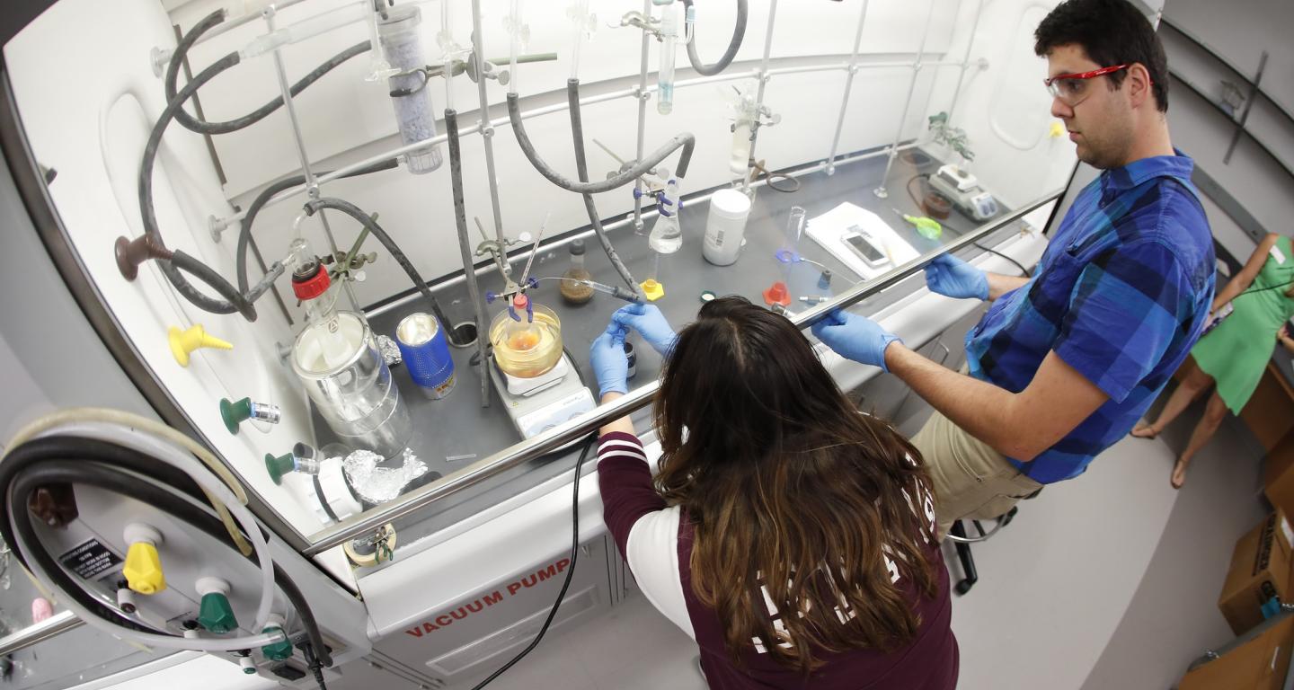 A North Central College chemistry student works on an experiment.