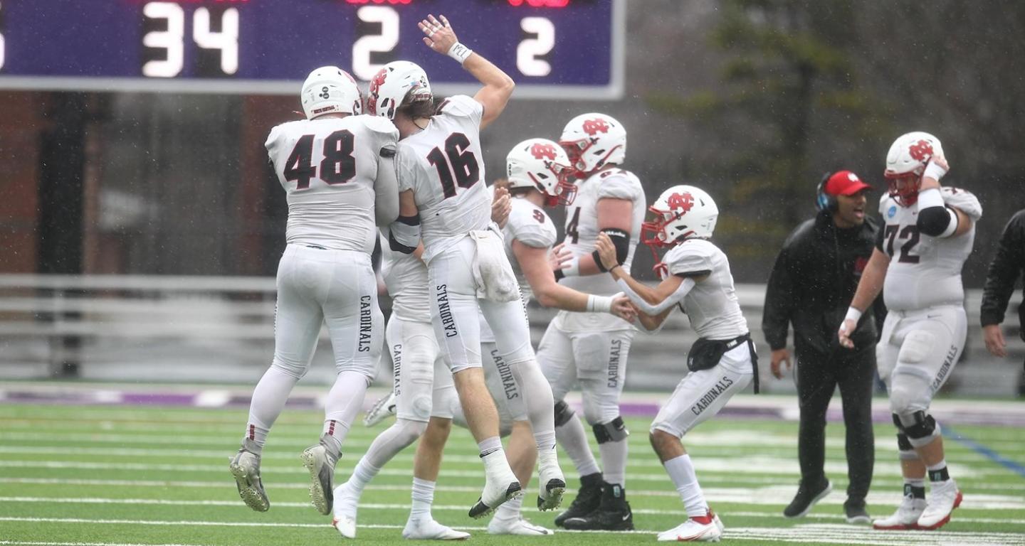 The North Central College football team celebrates after winning the national semifinals.