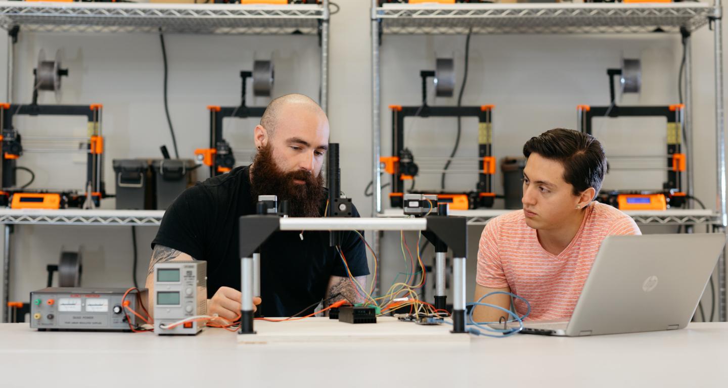 Two North Central College mechanical engineering students work on a project.