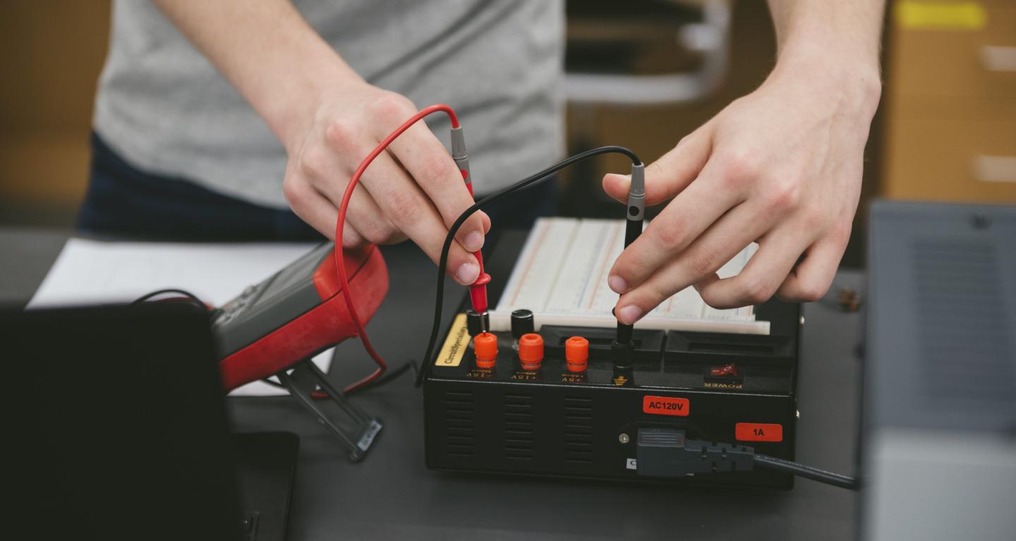 A North Central College electrical engineering student working with an instrument.
