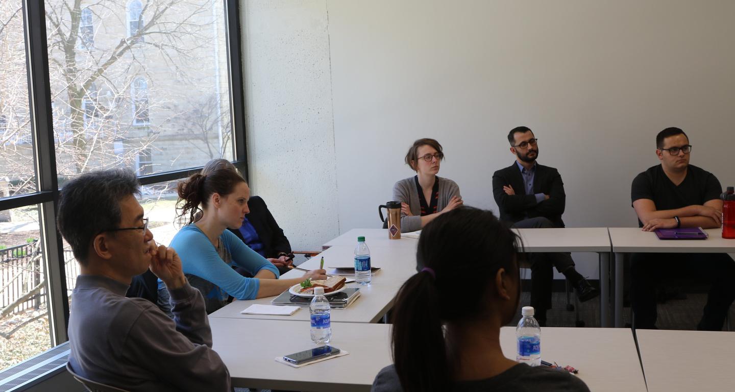 North Central College economics students and faculty engage in a discussion.