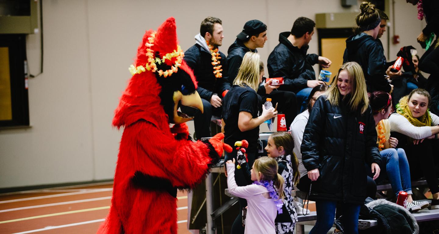 North Central College sport mangement students introduce the North Central mascot to some young fans.
