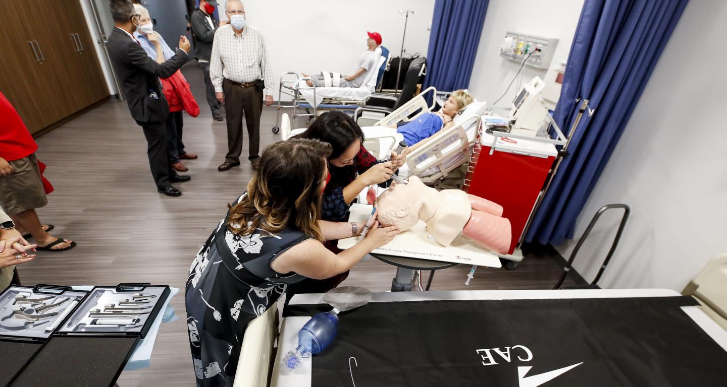 North Central College health science students working on a simulation dummy.