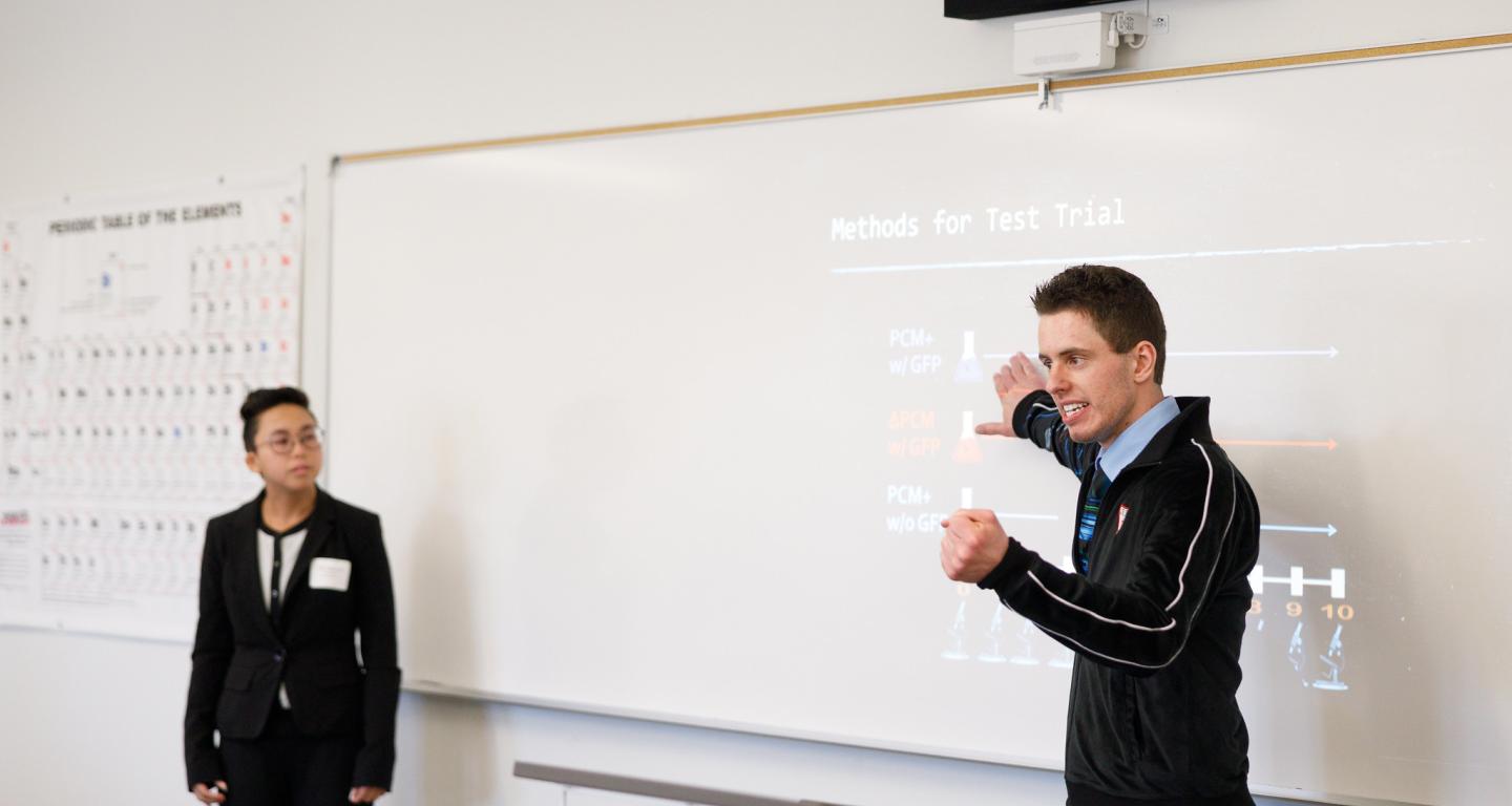 Two North Central College criminal justice students giving a presentation.