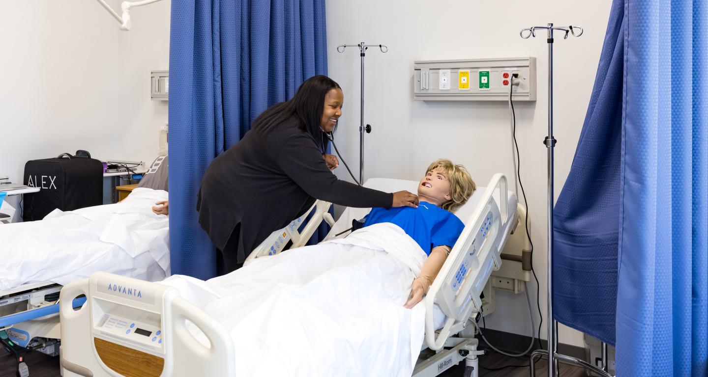 A North Central College health science student works on a simulated patient.