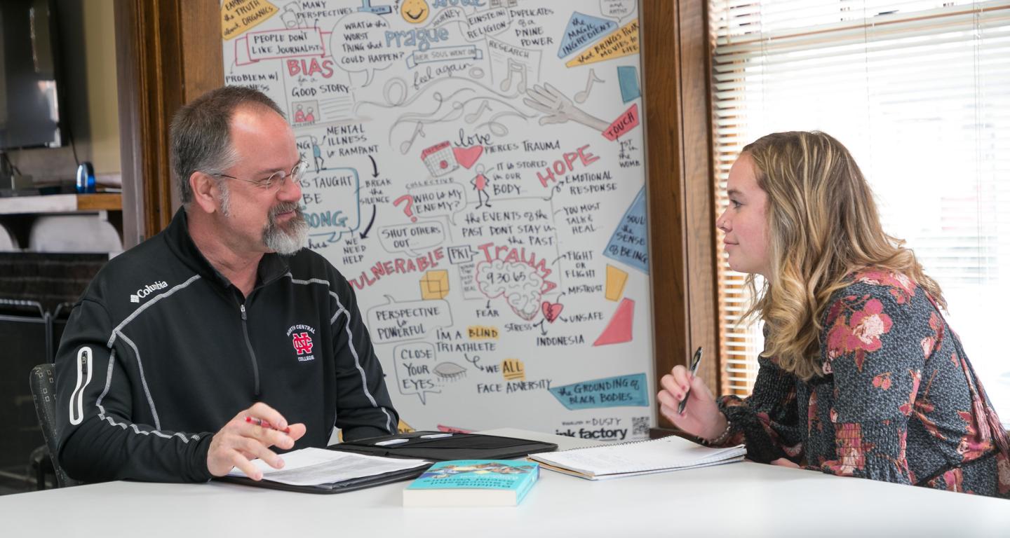 A North Central College ethics student in a discussion with a professor.