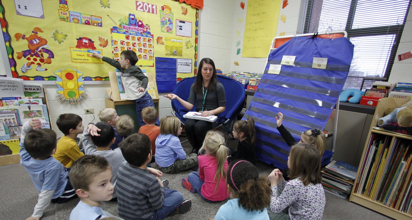 A North Central College elementary education student working with a room full of children.