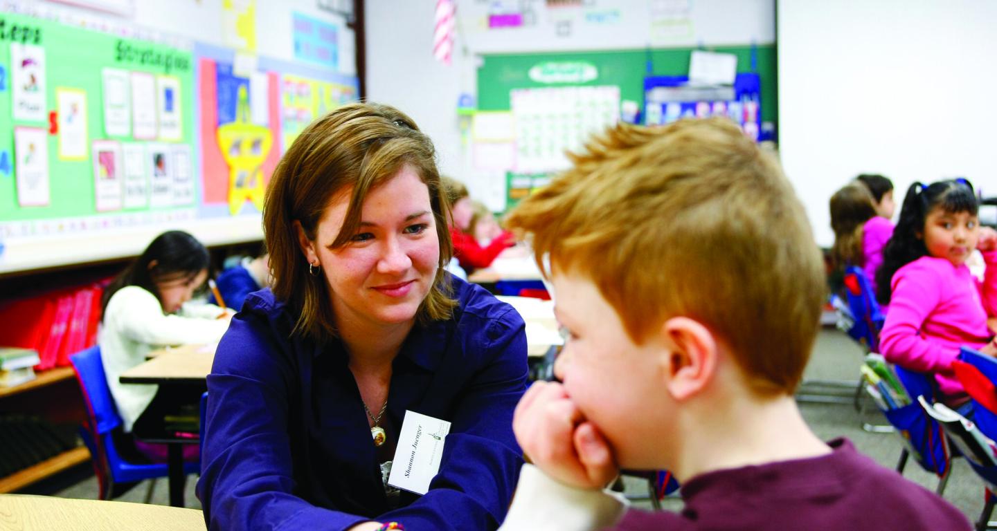 A North Central College student works in an elementary school classroom.