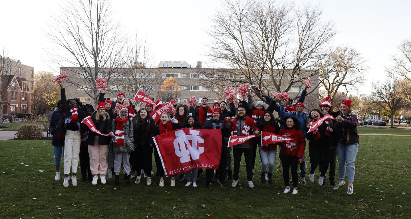 North Central College students jumping in the air.