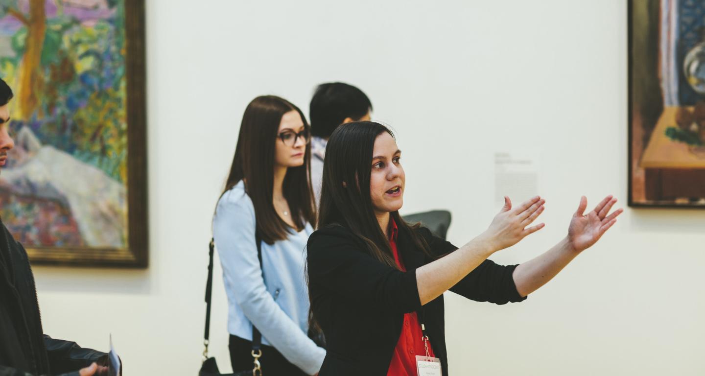 A North Central College art history graduate giving a museum tour.