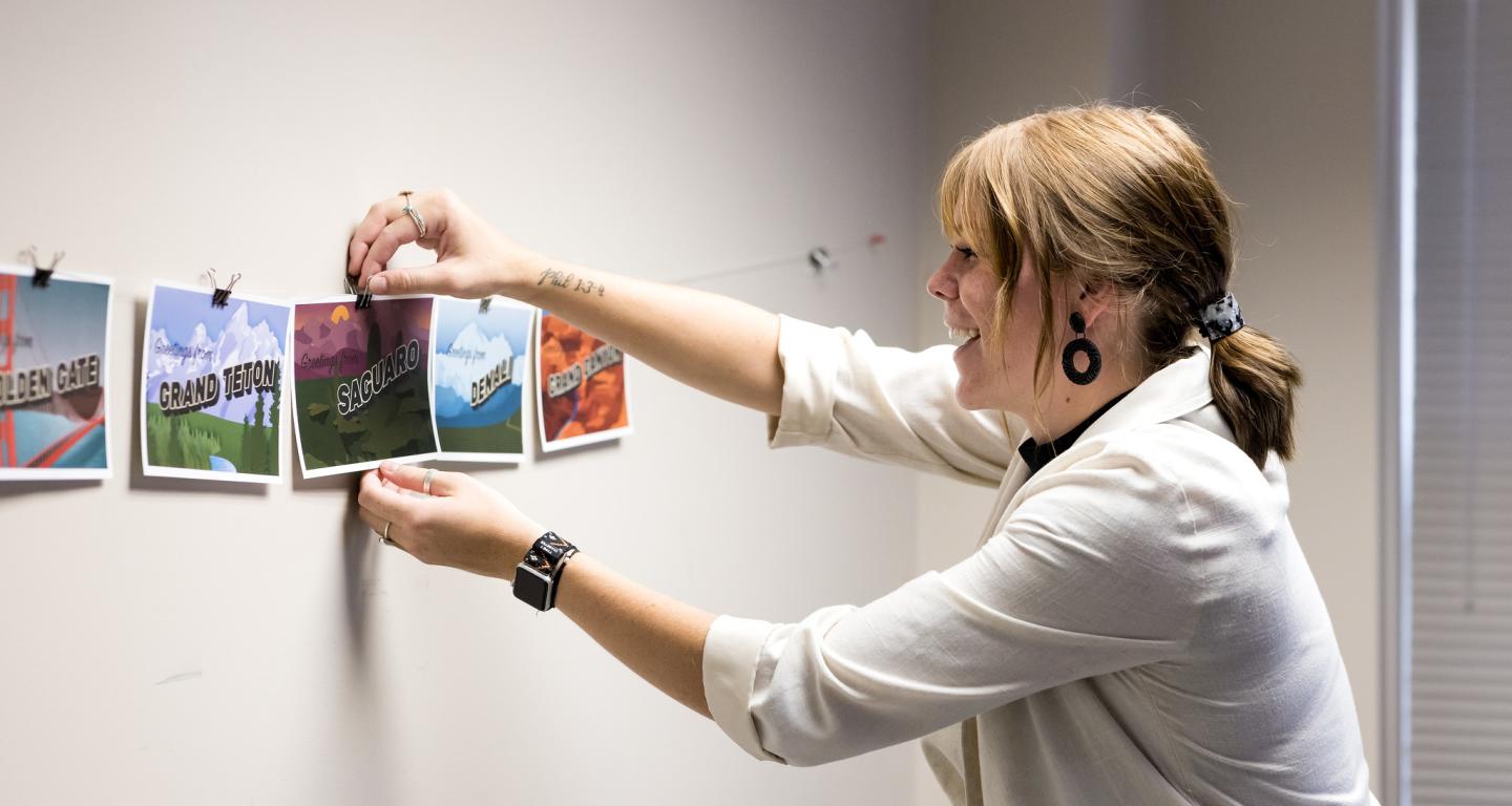 A North Central College art history student arranging photographs.