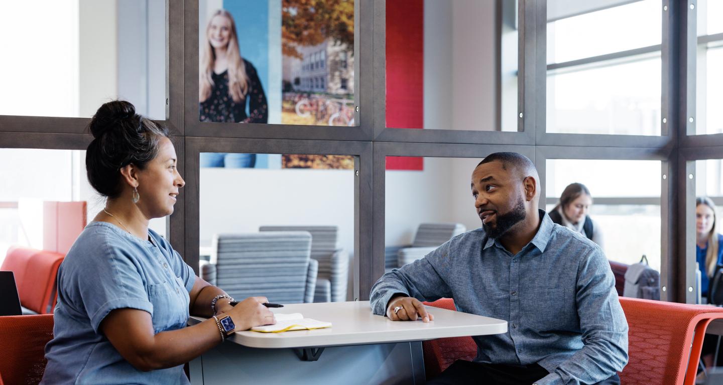 Two North Central College human resources students having a discussion.