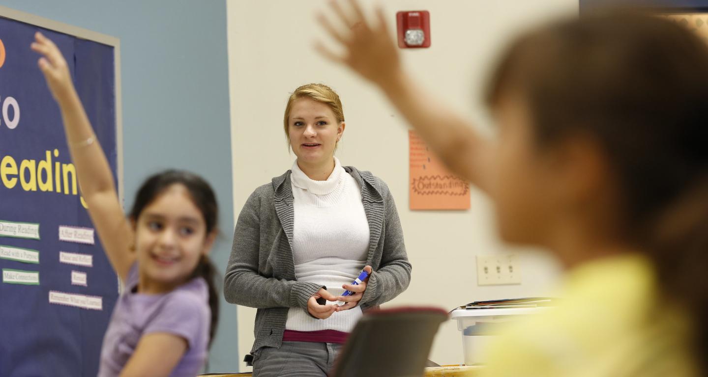 A North Central College special education student works with young children.