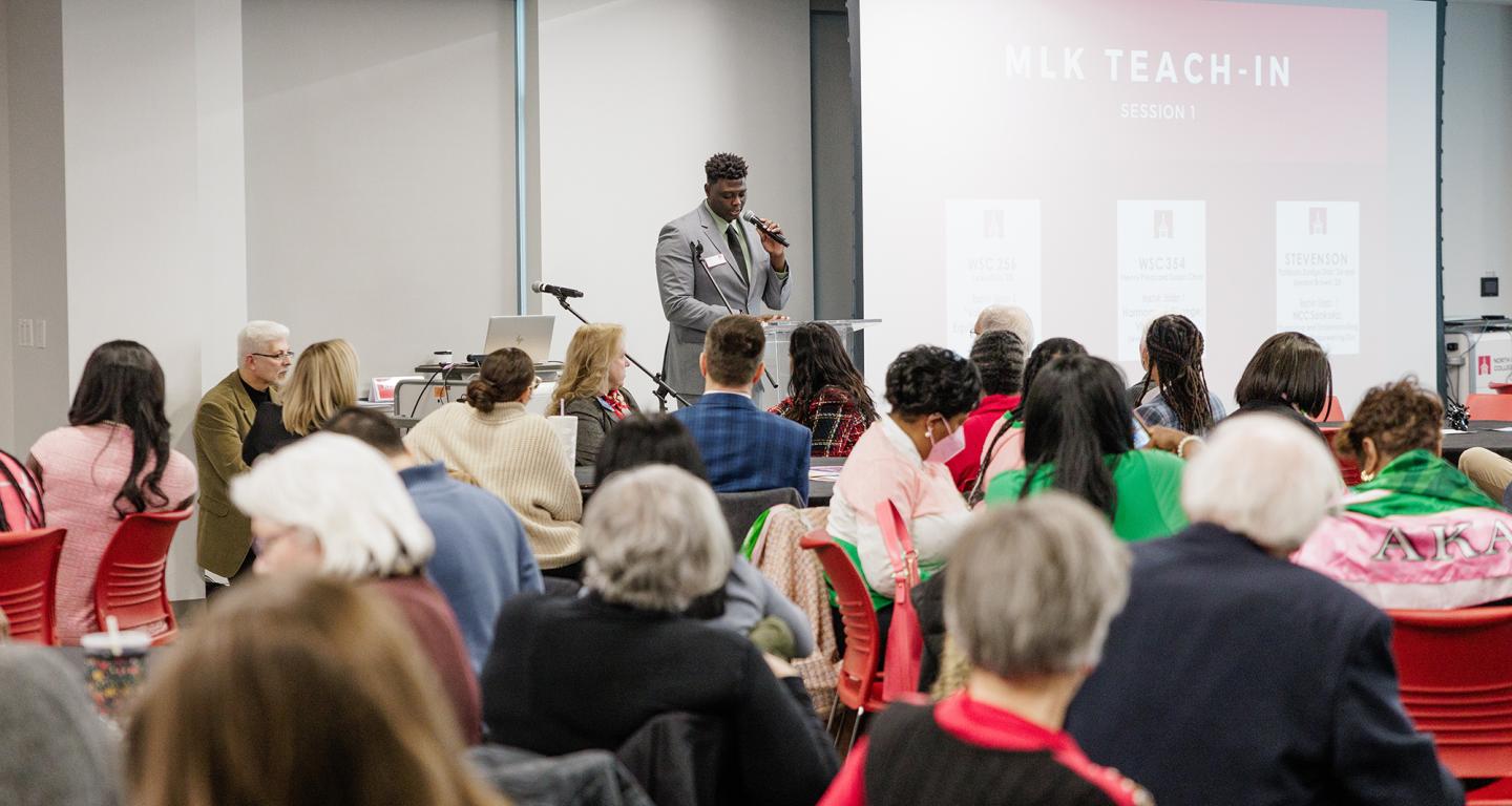Karl Constant leads a prayer at the beginning of North Central College's MLK Day.