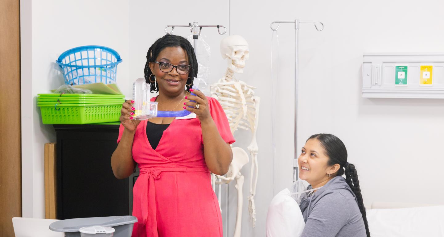 Occupational therapy professor and student leading a class demonstration
