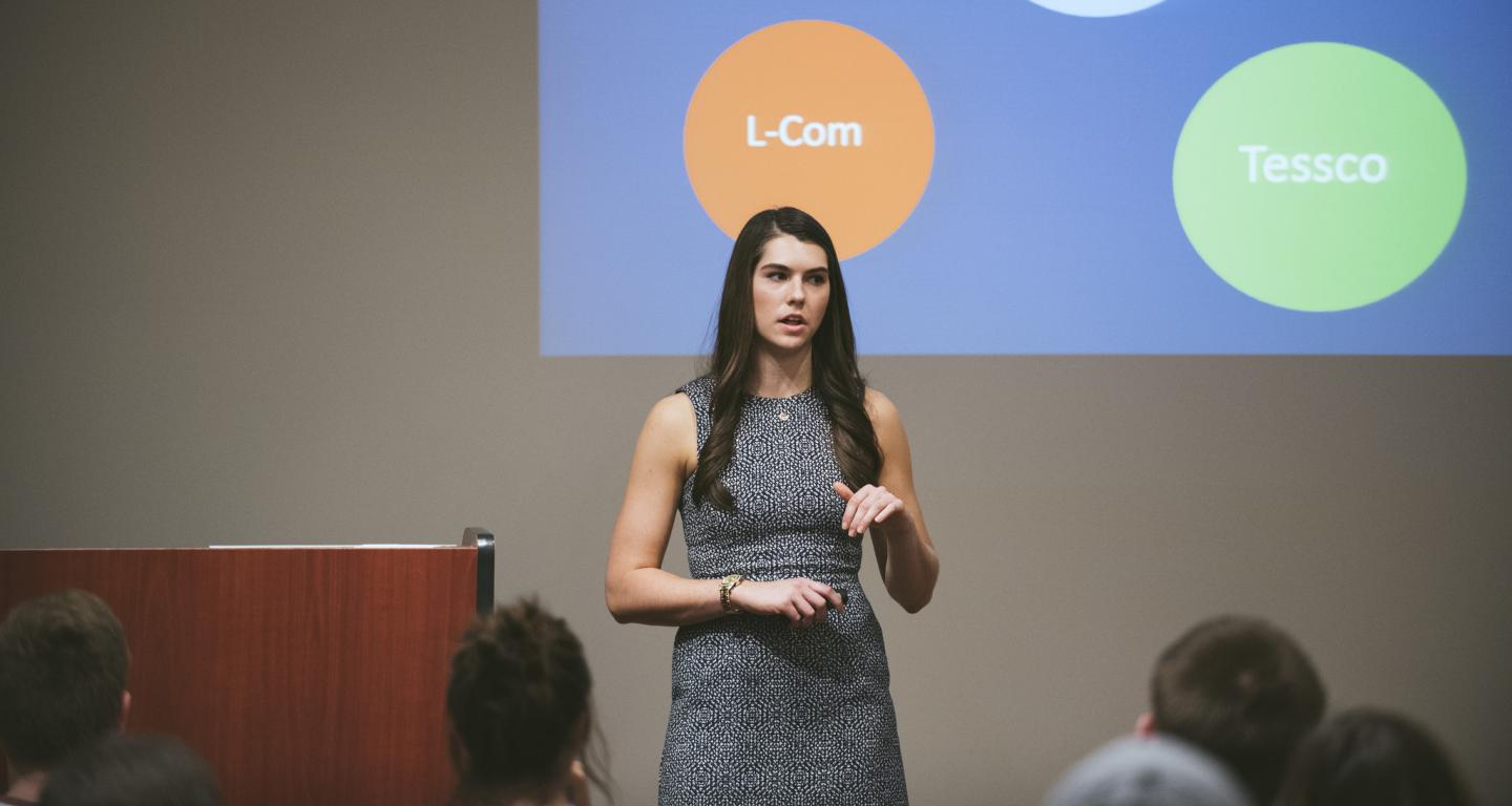 A student presenting while working on her international business degree.