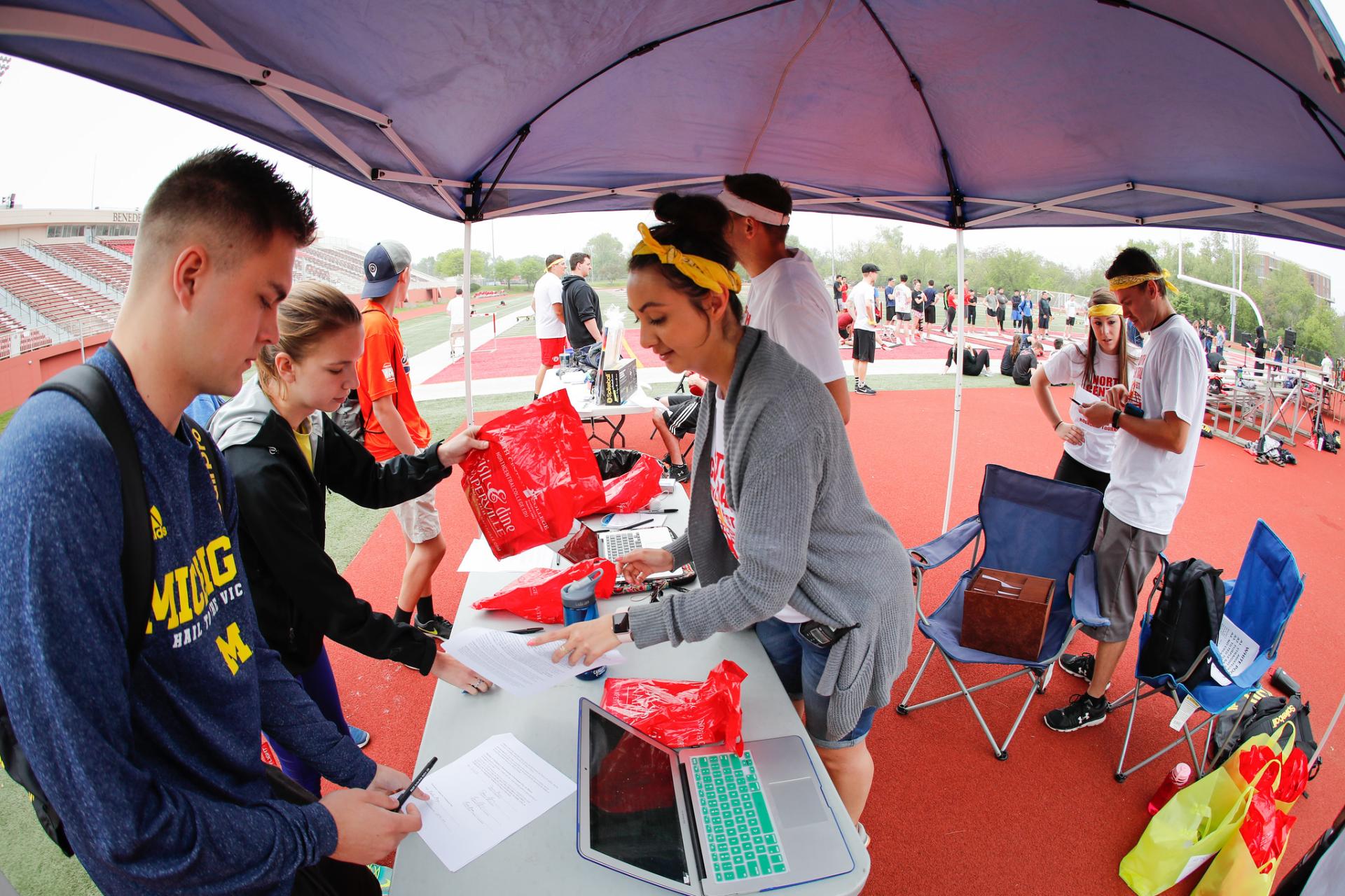 Sport management students signing in teams to the event.