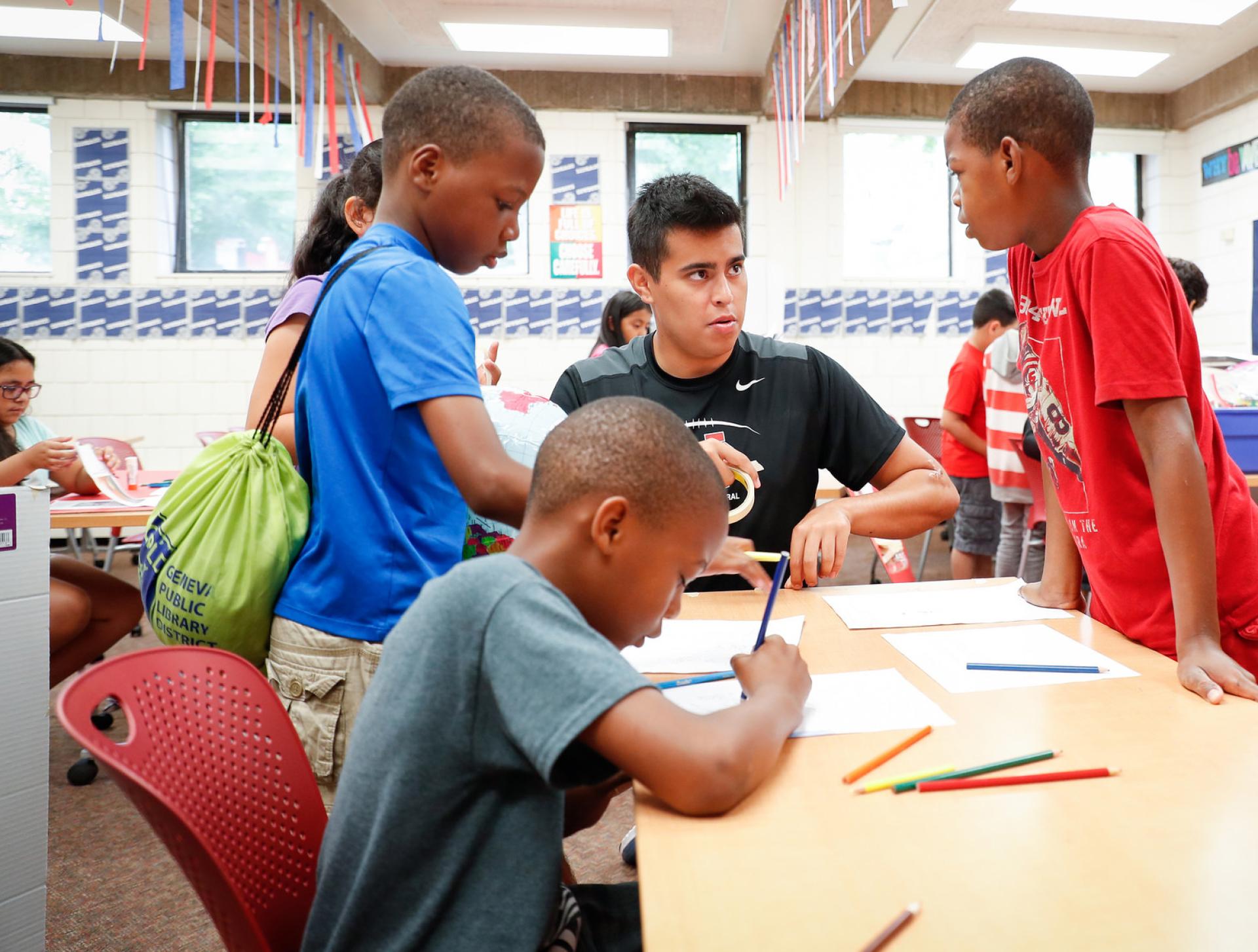 A JSS student working with children at an elmentary school.
