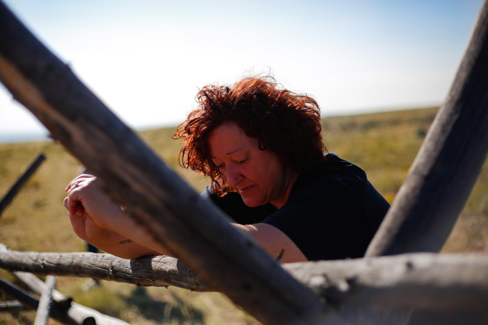 Carin Silkaitis reflects at the fence Matthew Shepard was left on