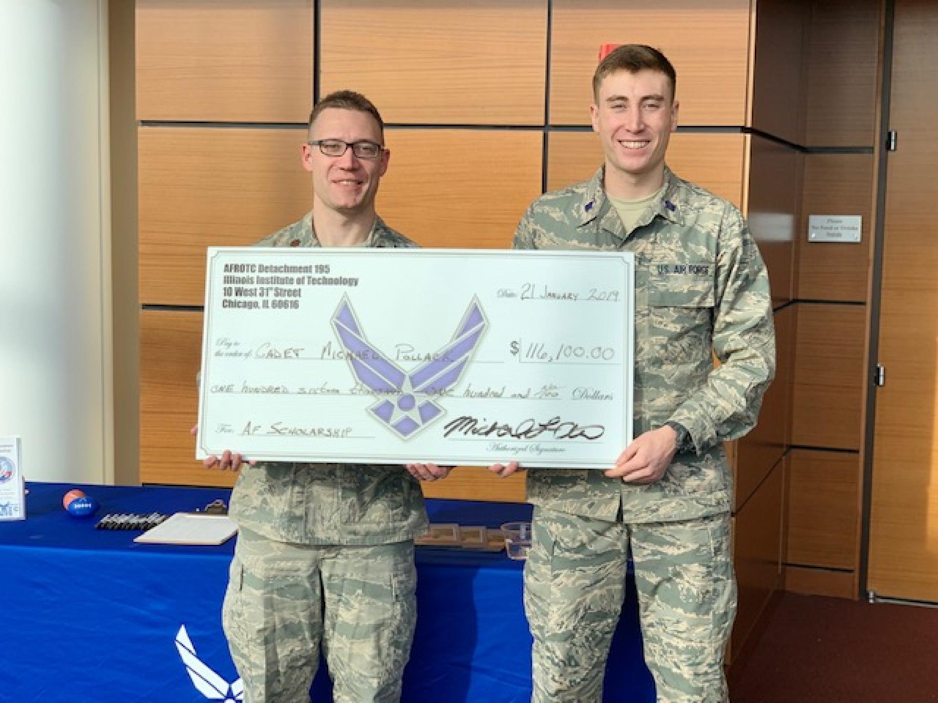 Major Jason Sterr presents a scholarship check to U.S. Air Force cadet and ROTC student Michael Pollack '21 of North Central College.