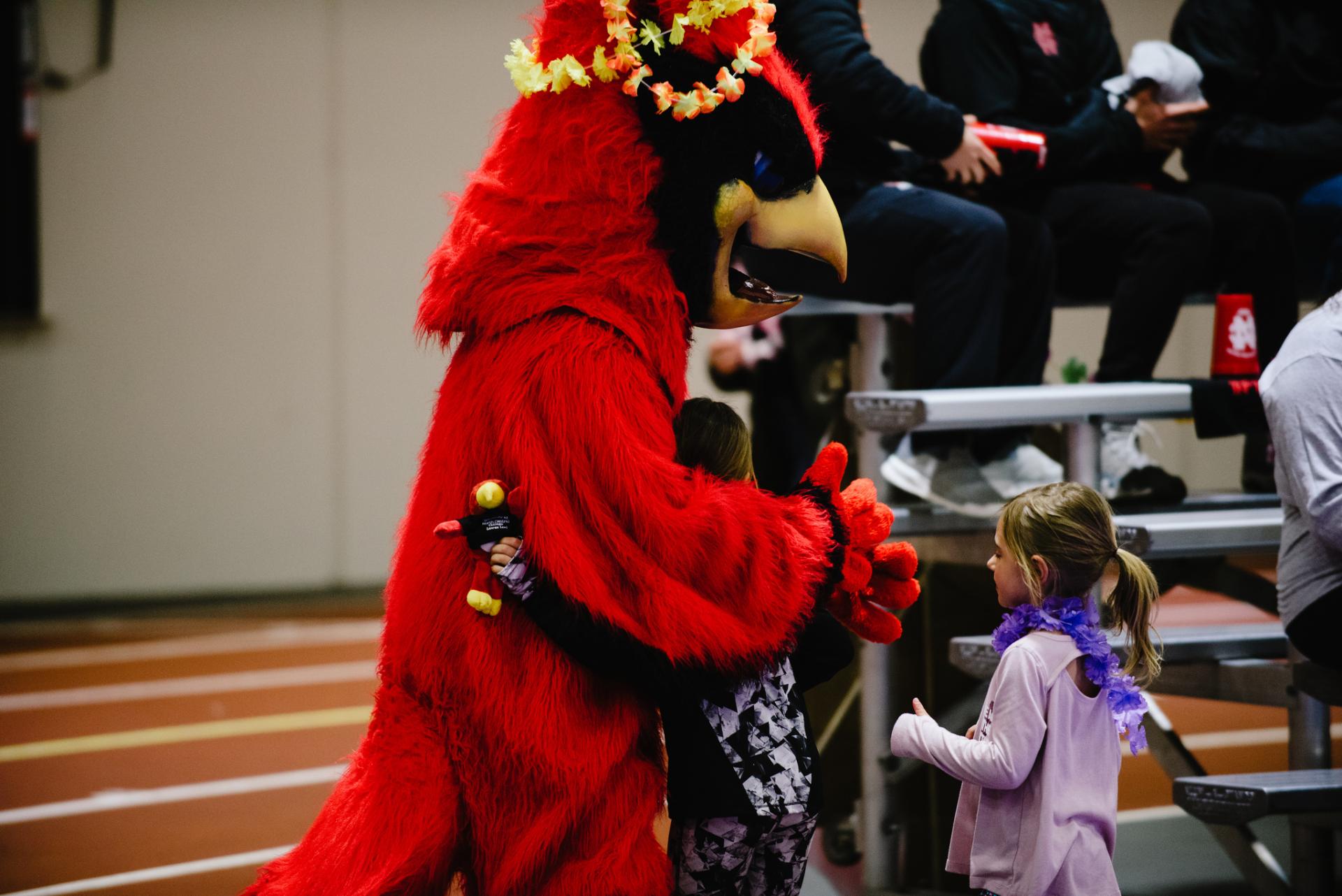 North Central mascot Chippy greets some young volleyball fans.