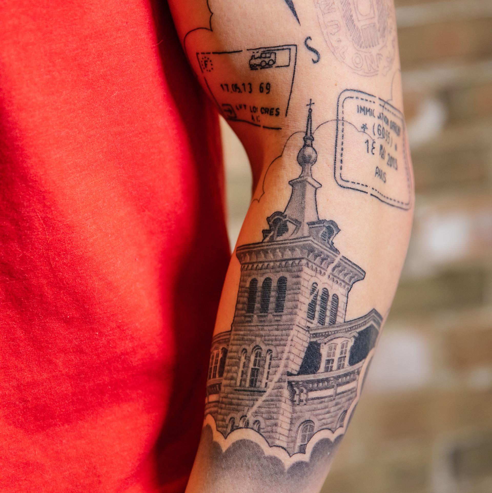 North Central College alumnus Kurt Alexander shows off his arm tattoo of Old Main.